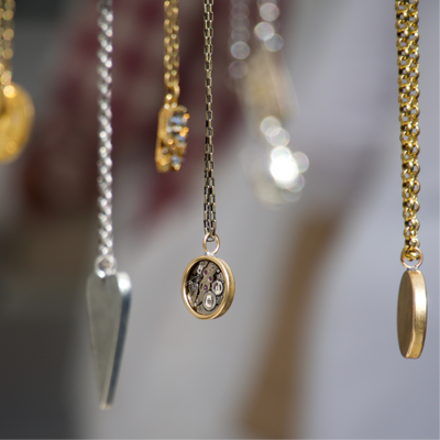 close-up of hanging gold and silver necklaces